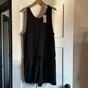 NWT! Women’s black romper with an adjustable waist and cute peep hole in back.